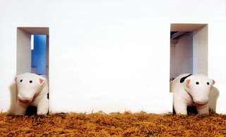 Piero Golia, Le mucche per Morra, 2000: due mucche antistress giganti incastrate nelle porte della galleria; Courtesy Studio Morra, Napoli, foto B. Iodice