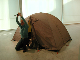 As soon as possible. Performance loop. The Class of Marina Abramovic - Braunschweig School of Art, Lotte Lindner, "Mountain".

The performative installation shows a room in a room: a tent as the smallest private space. You can not find out what the performer does inside. At the same time it becomes a sculpture itself. Room will be inside and out as the performer comes out of the tent from time to time only to show his pride: this is the conquest of time and space.

The performer Lotte Lindner is born 1971 in Bremen, Germany. She lives and works in Hannover. At Braunschweig School of Arts she studied sculpture, since 2000 she studied with Marina Abramovic. In 2003 she finished artschool.

She understands performance as a possibility for temporary sculpture.