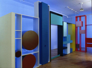 Tobias Rehberger, Luci diffuse, Jack Lemon's legs and other libraries, 2000, MDF, paint, televisions, VCR