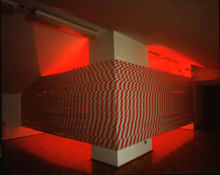 Liliana Moro, This is the end, 2004
Reflecting ribbon with strips, red light, audio system
190 x 5,5 x 17 cm
Courtesy: Galleria Emi Fontana, Milano 