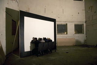 Memories and Encounters. Xabier Salaberria, Dragana Sapanjoš, Pavel Sterec, Evening Star, 2008
A row of cinema seats is placed right in front of the cinema screen. The audience (performers) sit on the seats resting their palms on the screen. Their thumbs simultaneously exert pressure on their closed eyes. The pressure creates images inside the eye – an inner film. The time of the performance is similar to that of a feature film.